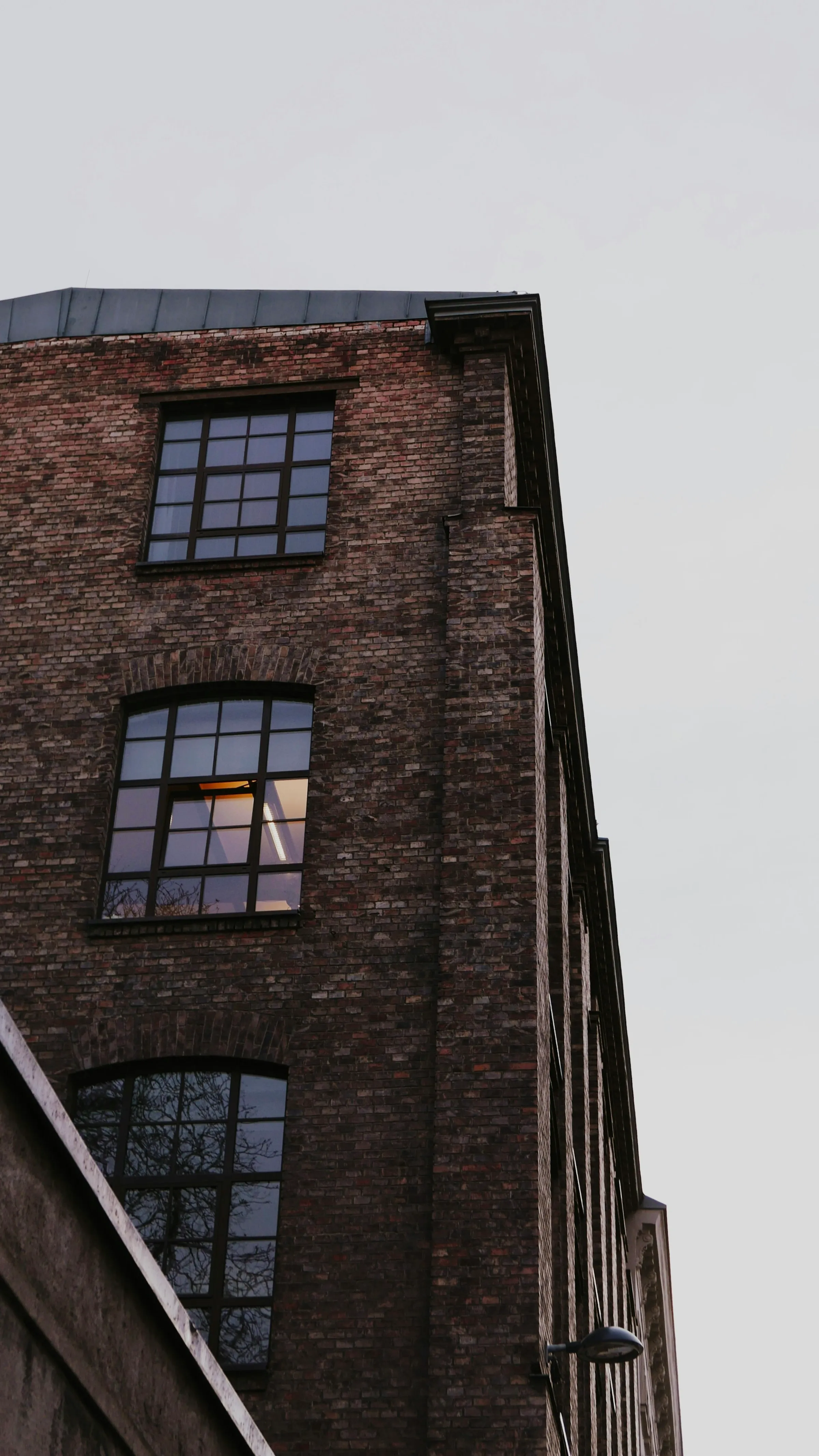 Brick building facade with illuminated windows
